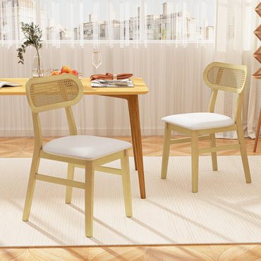 Goflame Dining table with two chairs in a bright room with large windows.